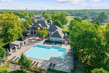 A large swimming pool in front of a house
